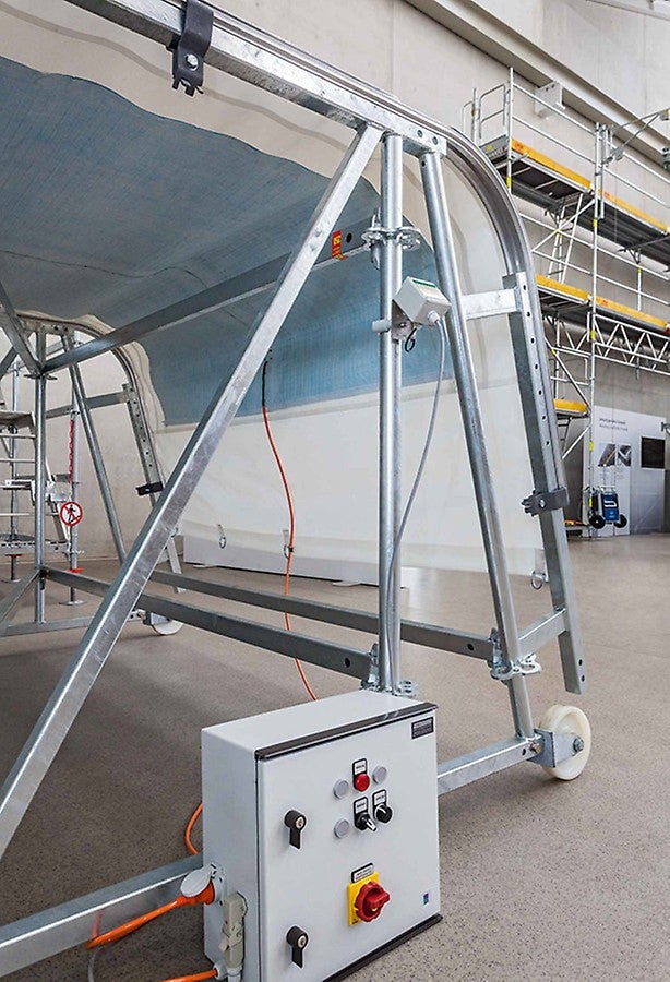 A sheeting which can be heated ensures that neither ice nor snow can accumulate on the weather protection roof. Such a solution eliminates not only the work required for clearing off the snow. In addition, the width and span can be increased when the roof is constantly free of snow which in turn brings time and cost savings.