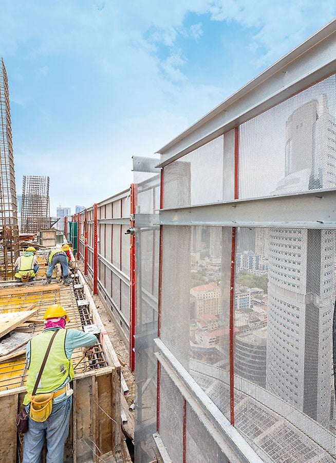 The perforated steel sheeting used as enclosure of the PERI RCS P climbing protection panel is particularly suitable for use in warmer regions. It is air-permeable and prevents heat accumulation inside the building.