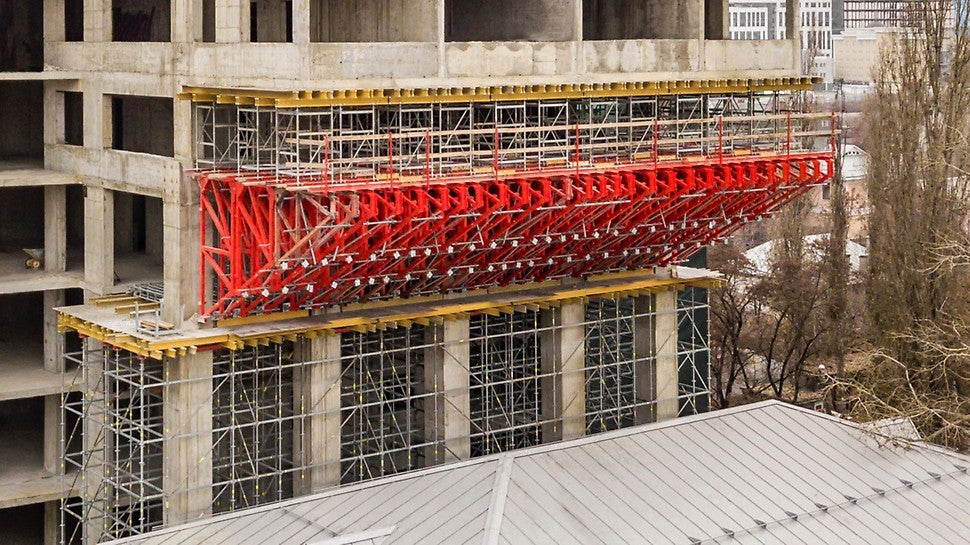 Основная сложность проекта заключалась в том, что строительство дома велось в буквальном смысле над другим зданием, которое расположено рядом и является объектом культурного наследия. Жилой дом выступает на 6 м и как будто накрывает сверху это здание. 