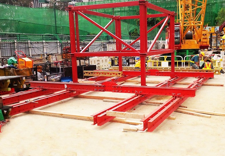 Initial assembly of single-lift platform on site. Note central platform opening for material transfer up and down the shaft. This central structure forms part of the &quot;trussed&quot; frame arrangement to transmit the imposed platform loads back to the 4 No. wall anchors. 