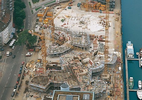 The three spectacular buildings of the new Zollhof complex in Dusseldorf during different stages of construction.