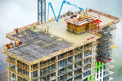 The formworks were configured to be self-climbing and suspended above the slab, ensuring the walls could be poured the same day as the slab.