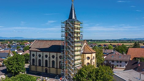 Der Turm der Kirche St. Stephan des Hartheimer Ortsteils Bremgarten ist zur Fassadensanierung und für Putzarbeiten derzeit bis zur Traufhöhe in über 25 m Höhe mit PERI UP Easy in Rahmenbauweise eingerüstet.