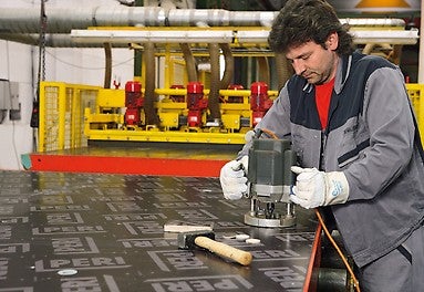 Smaller areas of damage to the formlining, mostly caused by concrete vibrators, are repaired with repair veneers.