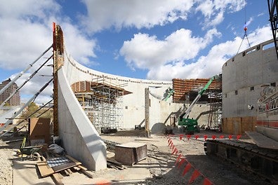A collection of interlaced concentric arches rising from the earth define the outer walls of the National Veterans Memorial and Museum.
