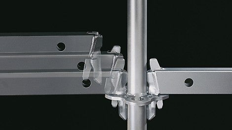 The gravity lock facilitates fast assembly of the modular scaffolding: by inserting the wedge head into the rosette, the wedge drops by force of gravity into the hole and then locks.<br/>