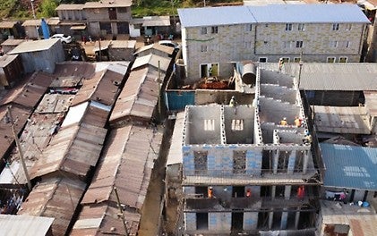 TwistBlock social housing under construction and an already completed residential block in the Kibera slum, Nairobi.