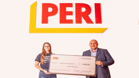 Strydom Groenewald, CEO of PERI USA, presented a $4,000 check to Victoria Onufrieff, donor database and relations specialist for Habitat for Humanity Chicago