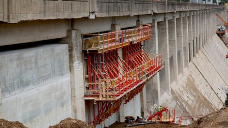 Concrete up to 14 ft thick is being added between the highway piers on the east and west retaining sections of the Bagnell Dam to add weight to the structure.
