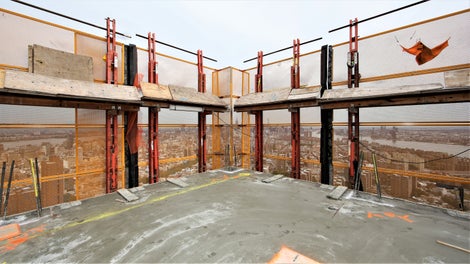 The screens have working platforms on each level at the edge of the slab and enclose 3 levels at a time.