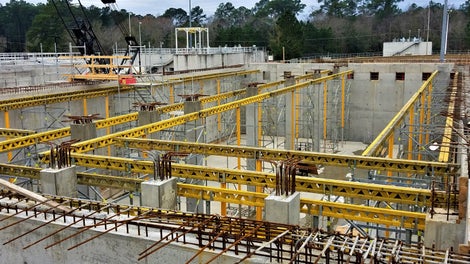 Preassembled towers are flown into place before the decking and reinforcement for the walkway is installed
