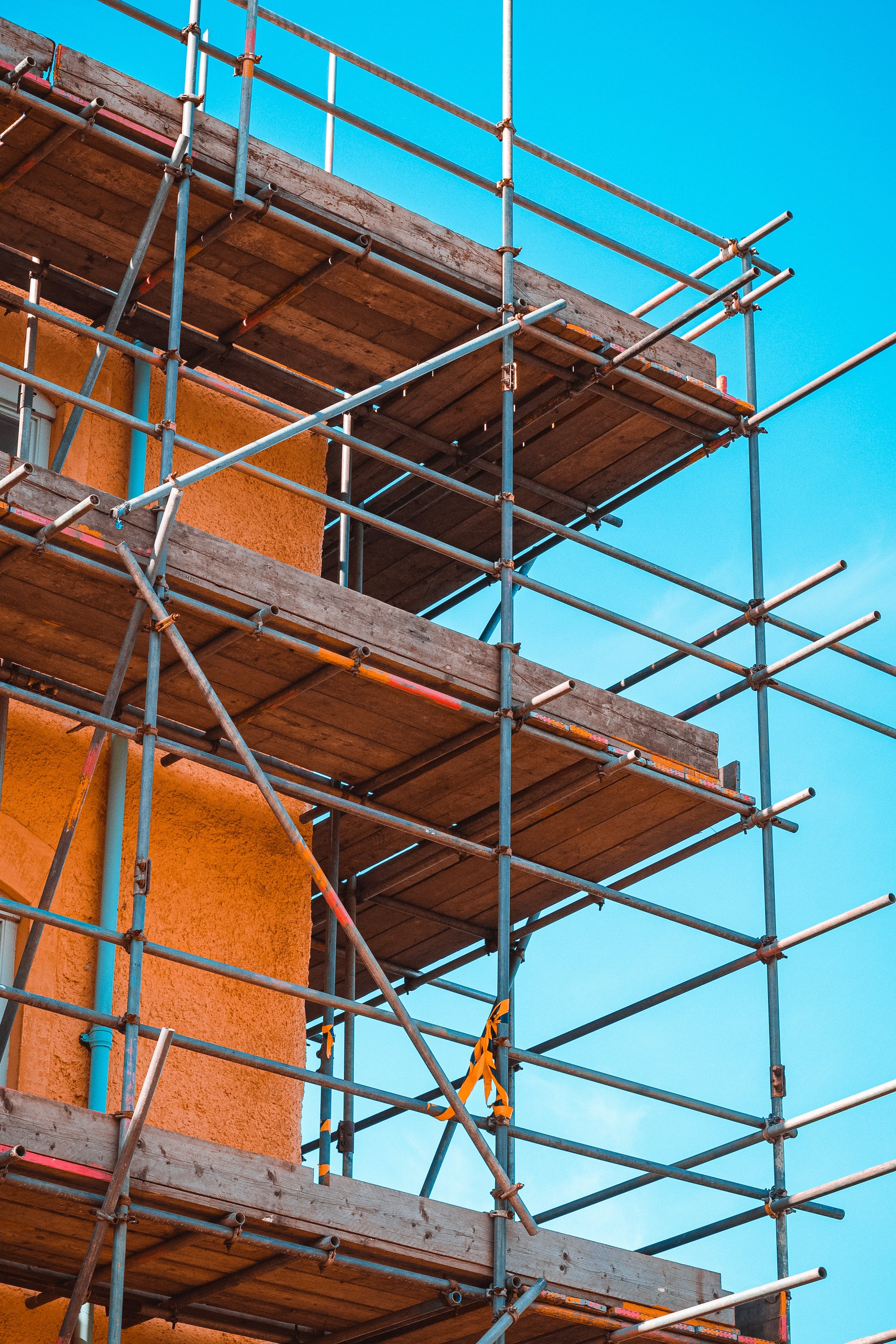 Surely using non-combustible materials around buildings that pose a fire risk should be a priority?